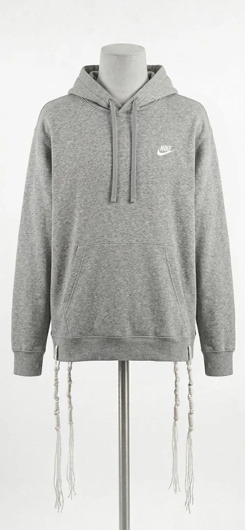 Piece 5: tzitzit tied into a Nike hoodie, heather grey, on a mannequin