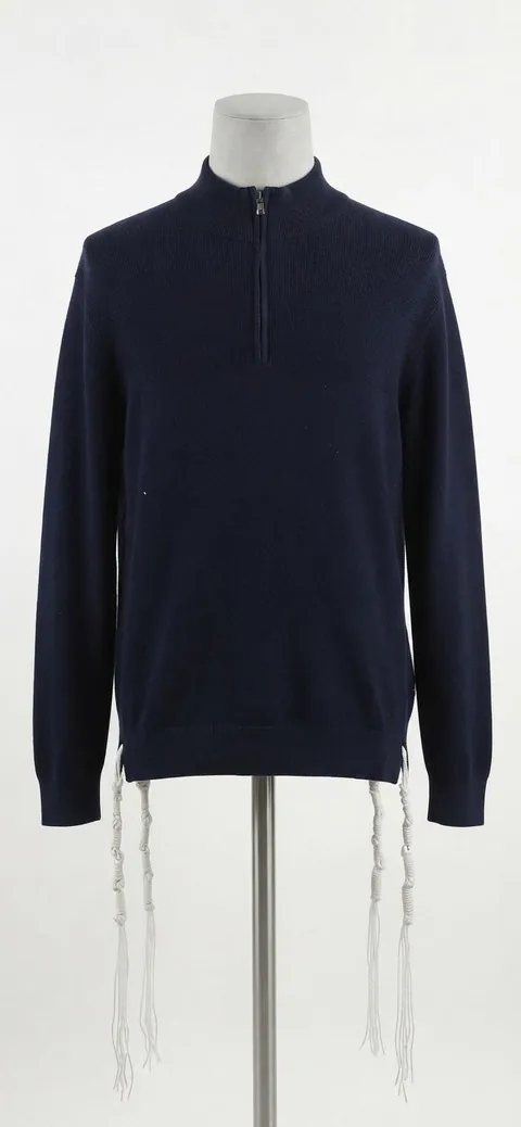 Piece 7: tzitzit tied into a navy quarter-zip, on a mannequin