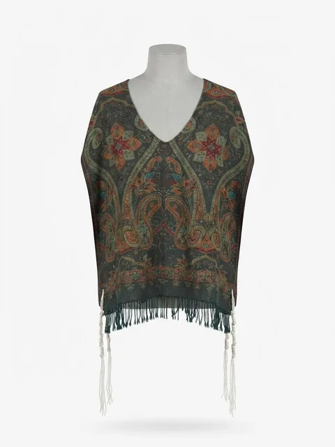 Piece 16: tzitzit tied into a green and rust paisley cloth, on a mannequin