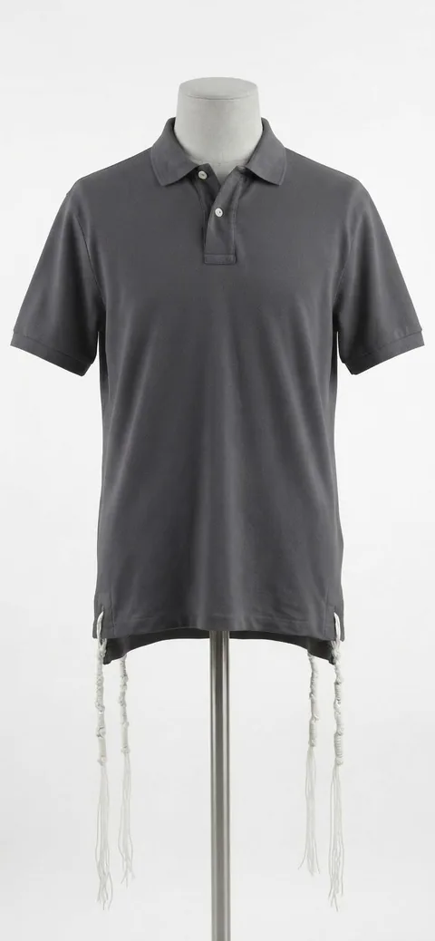 Piece 26: tzitzit tied into a charcoal polo, on a mannequin