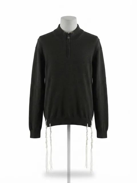 Piece 27: tzitzit tied into a black quarter-zip knit, on a mannequin